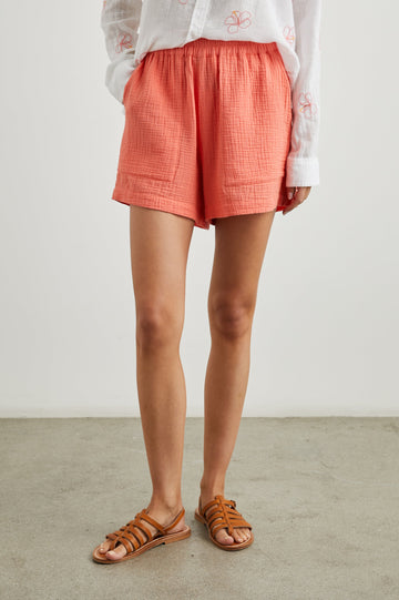 Leighton Shorts with Textured Fabric, a Smocked Elastic Waist, and Large Front Pockets in Papaya Colorway - Front View Featured on Model