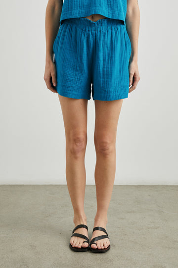 Leighton Shorts with Textured Fabric, a Smocked Elastic Waist, and Large Front Pockets in Turkish Tile Colorway, a Blue - Front View Featured on Model