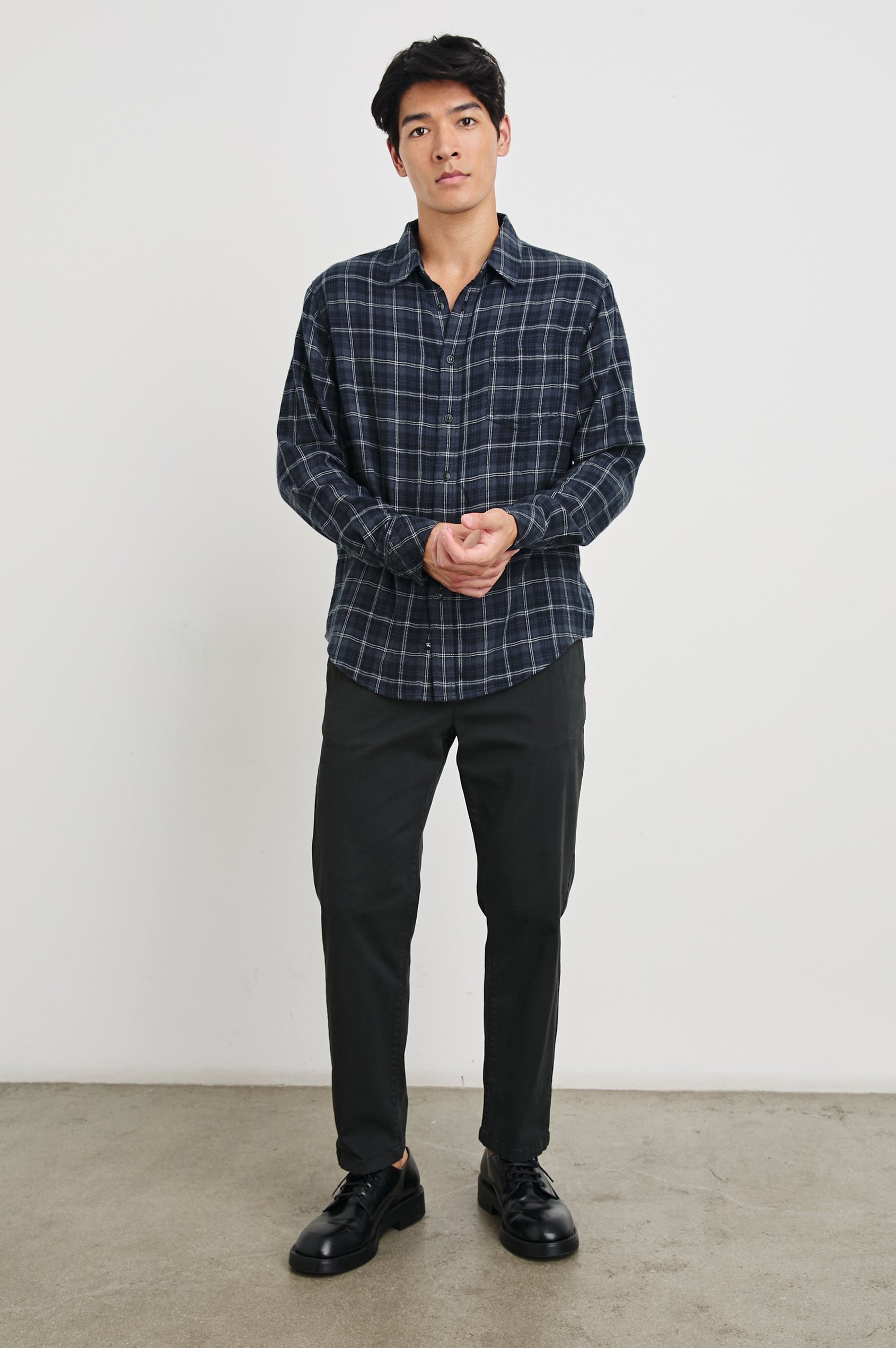Lennox Long-Sleeve Button Up with a Chest Patch Pocket in Black Blue Smoke Cinder Colorway, a plaid in Greys, Blues, and White - Front Full Body View Featured on Model
