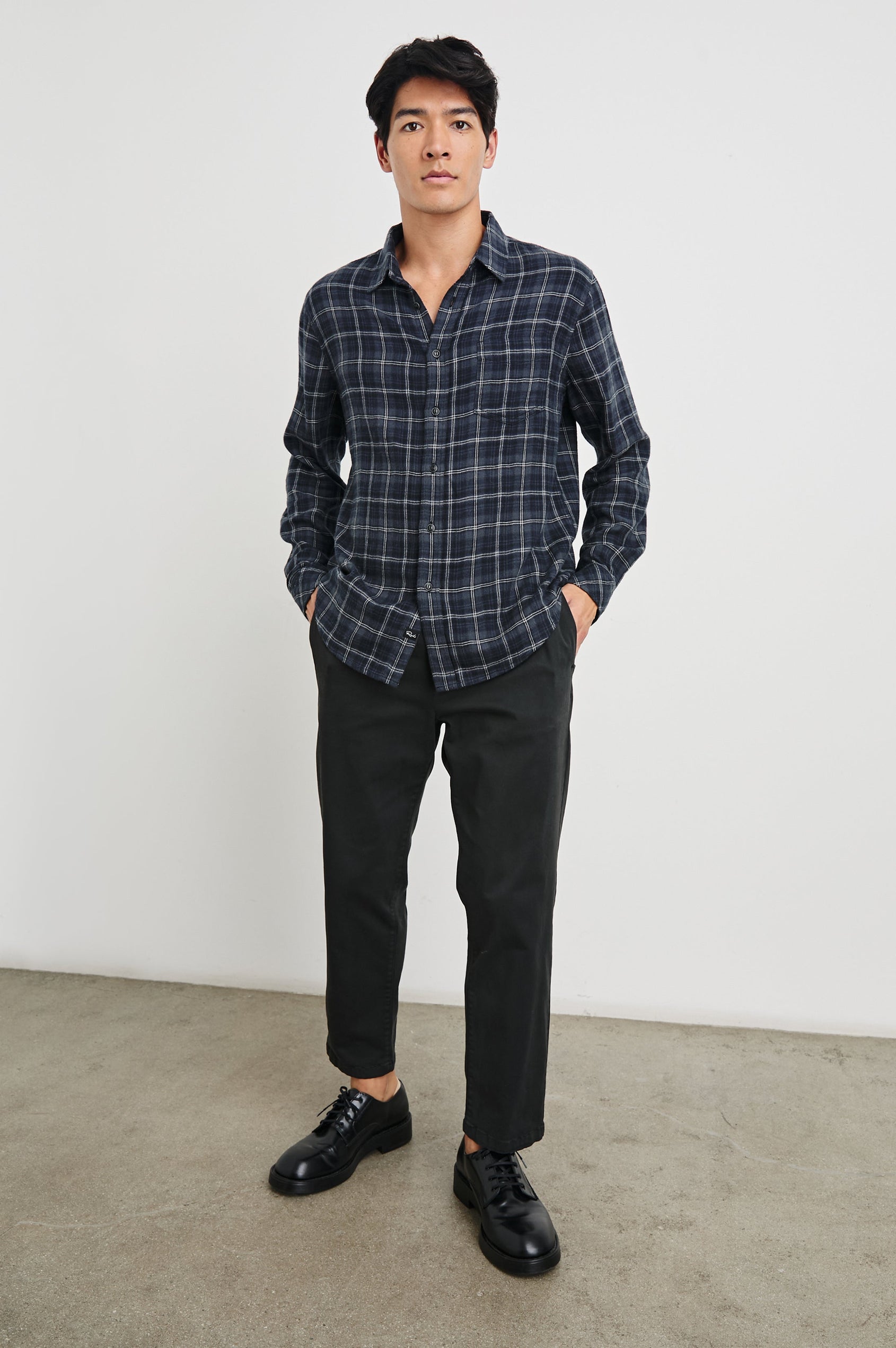 Lennox Long-Sleeve Button Up with a Chest Patch Pocket in Black Blue Smoke Cinder Colorway, a plaid in Greys, Blues, and White - Front Full Body View Featured on Model