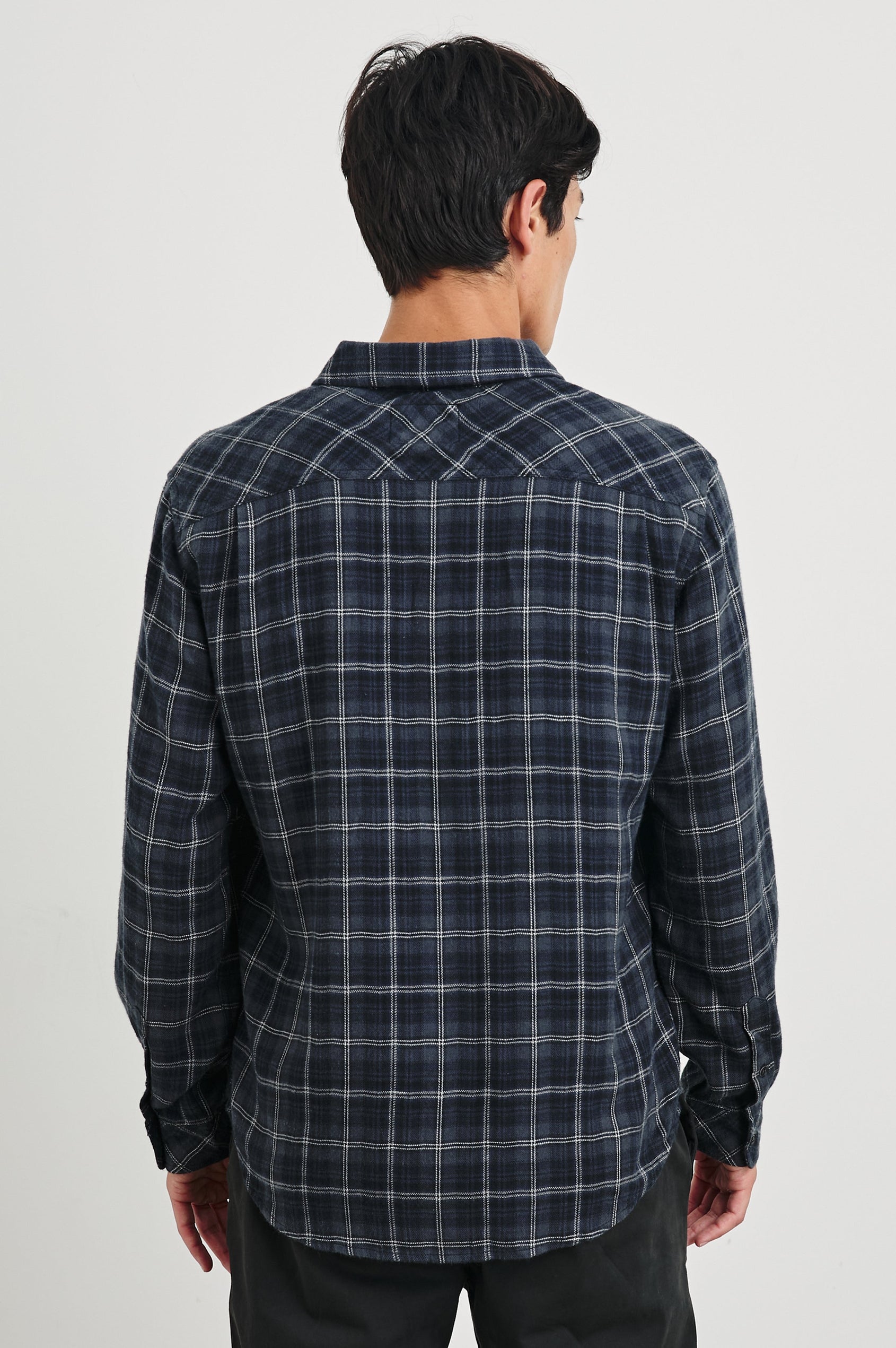 Lennox Long-Sleeve Button Up with a Chest Patch Pocket in Black Blue Smoke Cinder Colorway, a plaid in Greys, Blues, and White - Back View Featured on Model