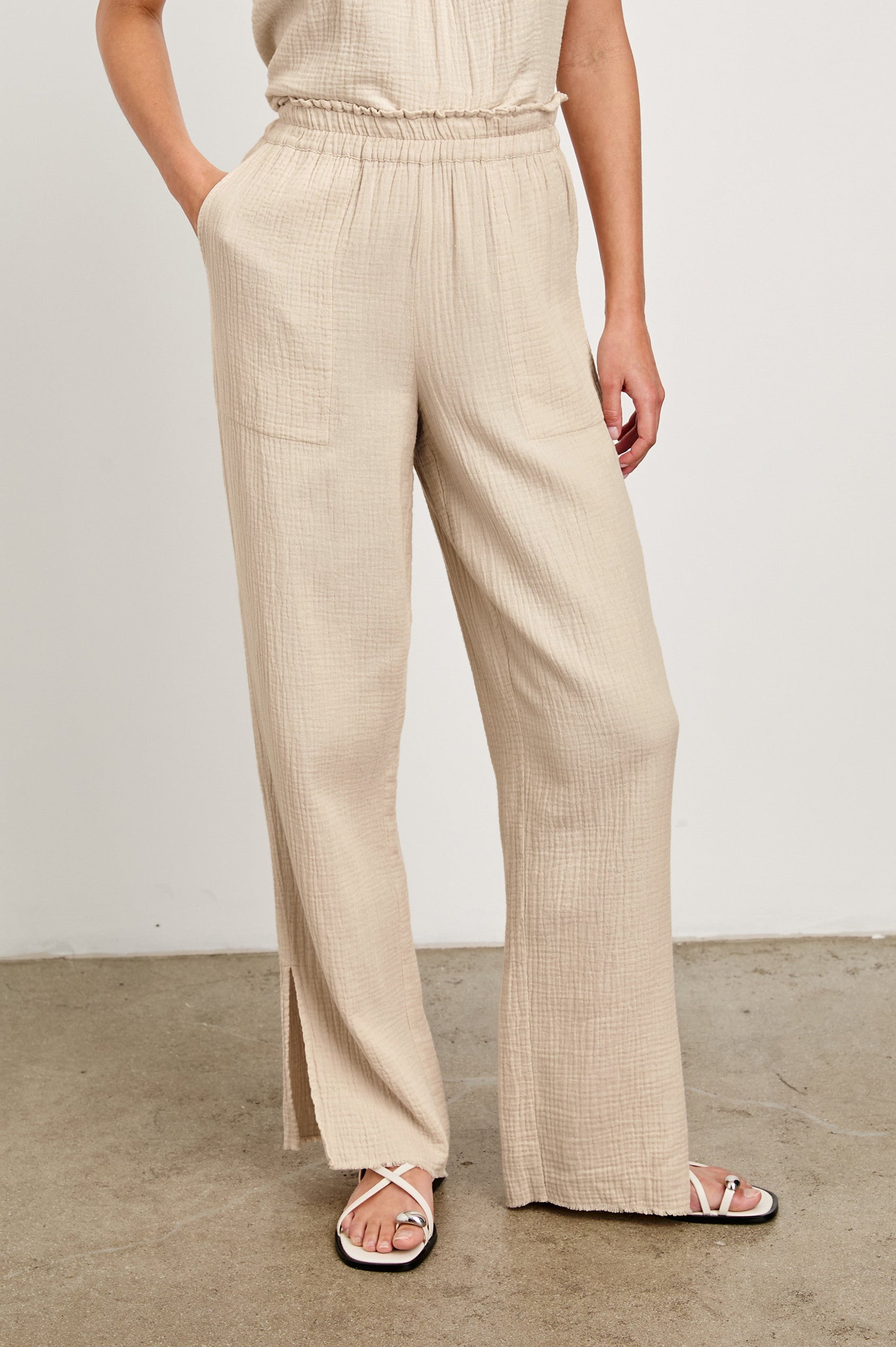 Leon Cotton Gauze Pant With Hemline Slit And Elastic Waist In Colorway Flax - Front View Featured On Model 