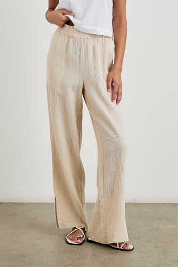 Leon Cotton Gauze Pant With Hemline Slit And Elastic Waist In Colorway Flax - Front View Featured On Model 