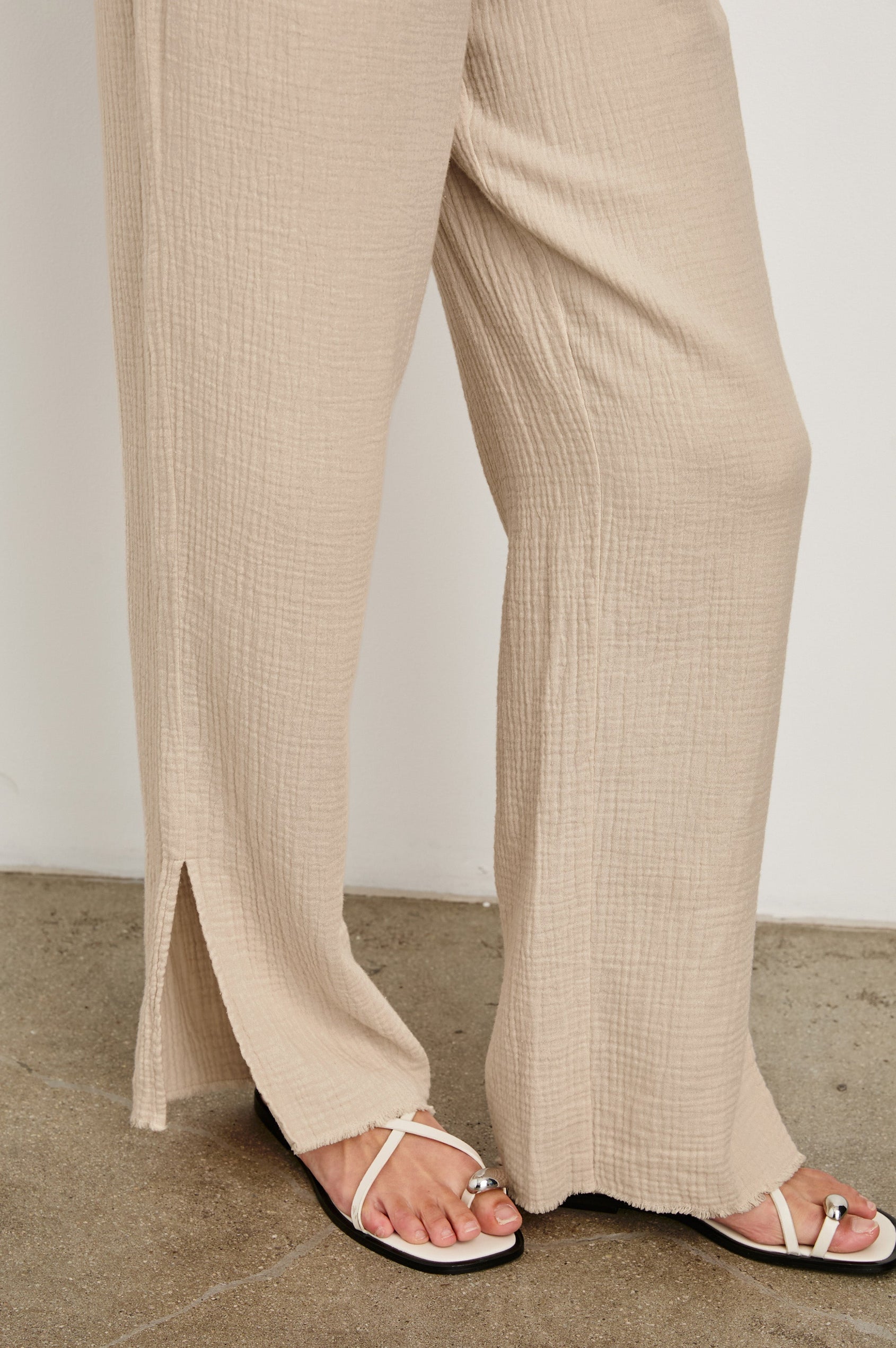Leon Cotton Gauze Pant With Hemline Slit And Elastic Waist In Colorway Flax - Hem Detail Featured On Model