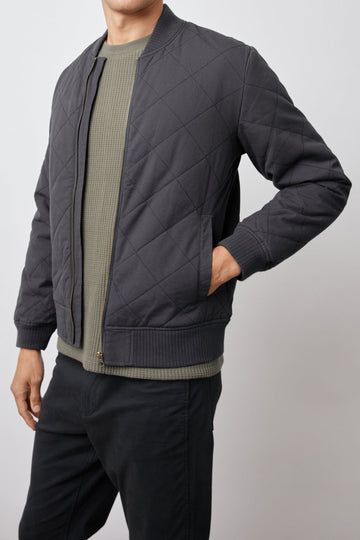 Peninsula Jacket with Zip Closure, Two Front Pockets, an Inner Zippered Pocket, a Quilted Pattern and Ribbed Trim in Washed Black Colorway - Front View Featured on Model