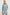 Lido collarless denim jacket with contrast blanket stitch details, chest pockets and embellishment buttons in Harbor Blanket Stitch - front view on model with matching skirt
