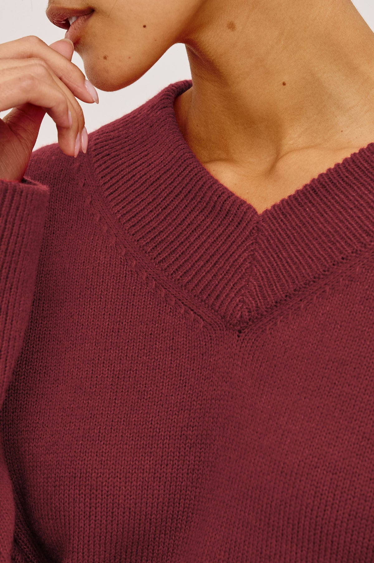 Lidya Sweater in Wool-Cashmere Knit Blend With V-Neckline, Loose Relaxed Fit, Long Sleeves, and Ribbed Trim in Crimson Colorway - Upper Body Front View Featured on Model