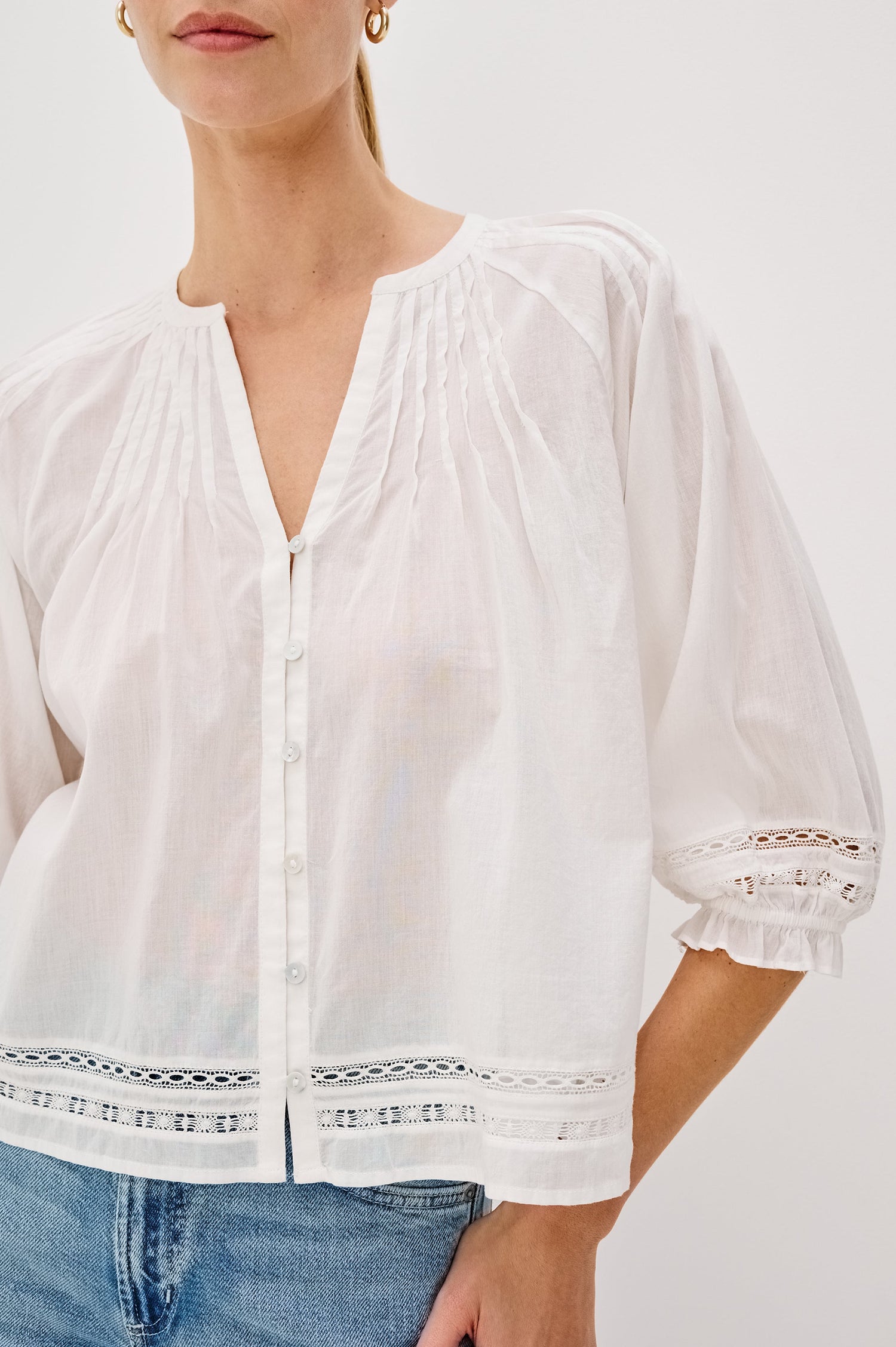Lilah Blouse with Elbow Length Sleeves, Elastic and Gathering at Sleeve Hem, V-Neck and 3-button Front, White Lace Details at Hems in White Colorway. Front Detail View Shown on Model.