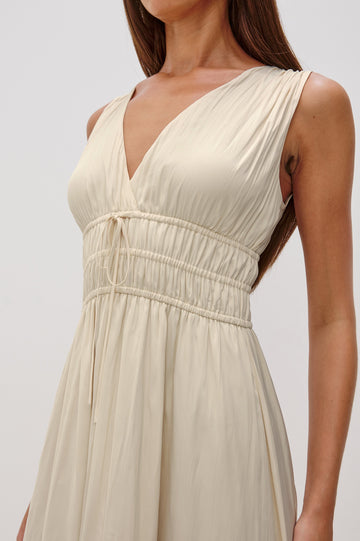Lilith V-Neck Midi Dress with Drawstring at Under Bust and Gathering Detail at Shoulder Seam and Waist in Ivory Colorway. Front Detail View Shown on Model.