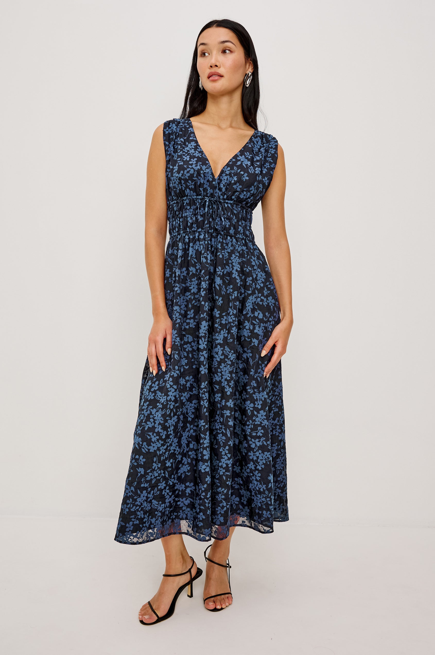 Lilith Midi Dress Crinkle Clip Jacquard With Plunging V-Neckline, Smocked Waist, and Back Ties in Midnight Silhouette Floral Colorway - Full Body Front View Featured on Model