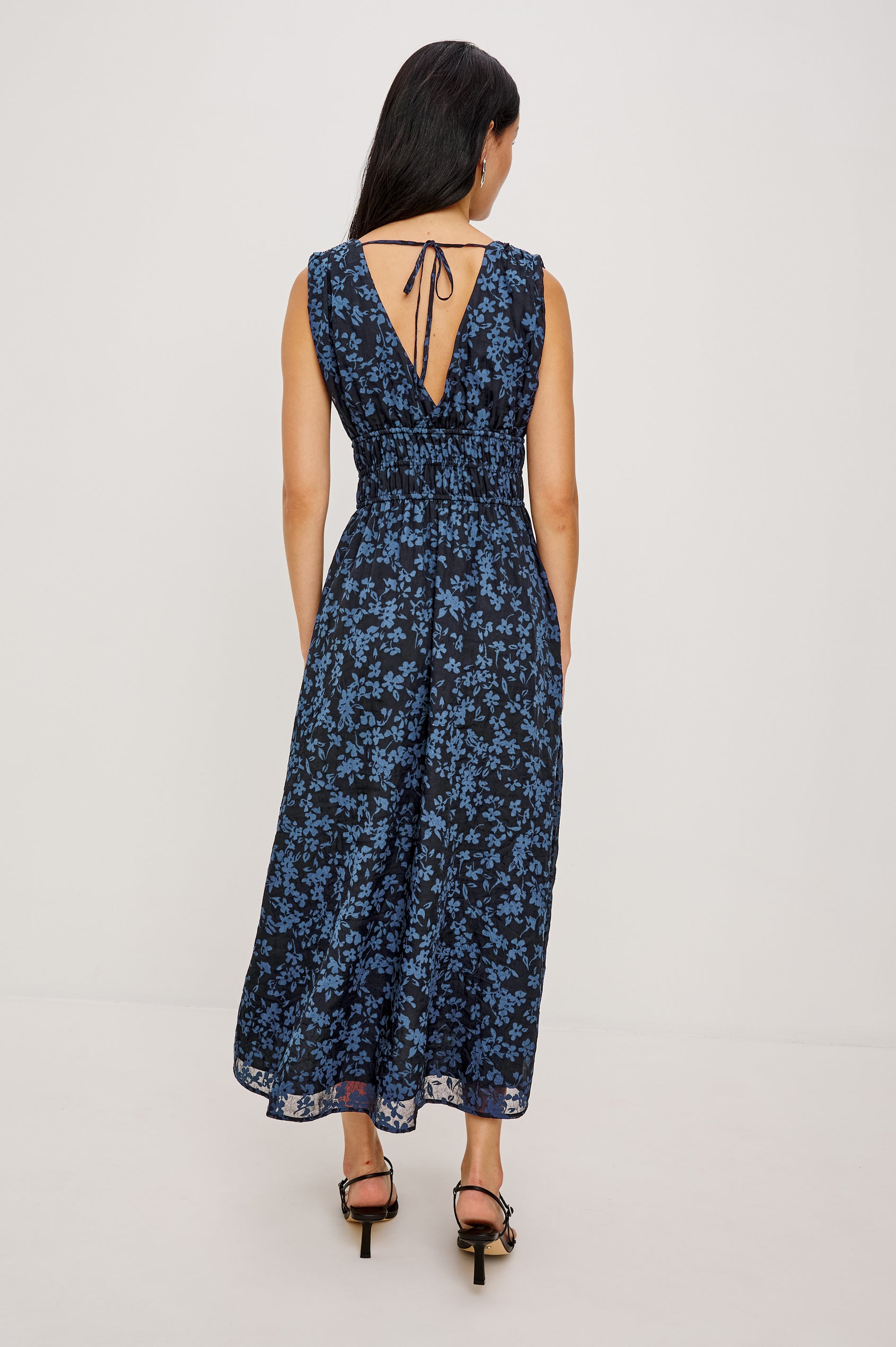 Lilith Midi Dress Crinkle Clip Jacquard With Plunging V-Neckline, Smocked Waist, and Back Ties in Midnight Silhouette Floral Colorway - Full Body Back View Featured on Model