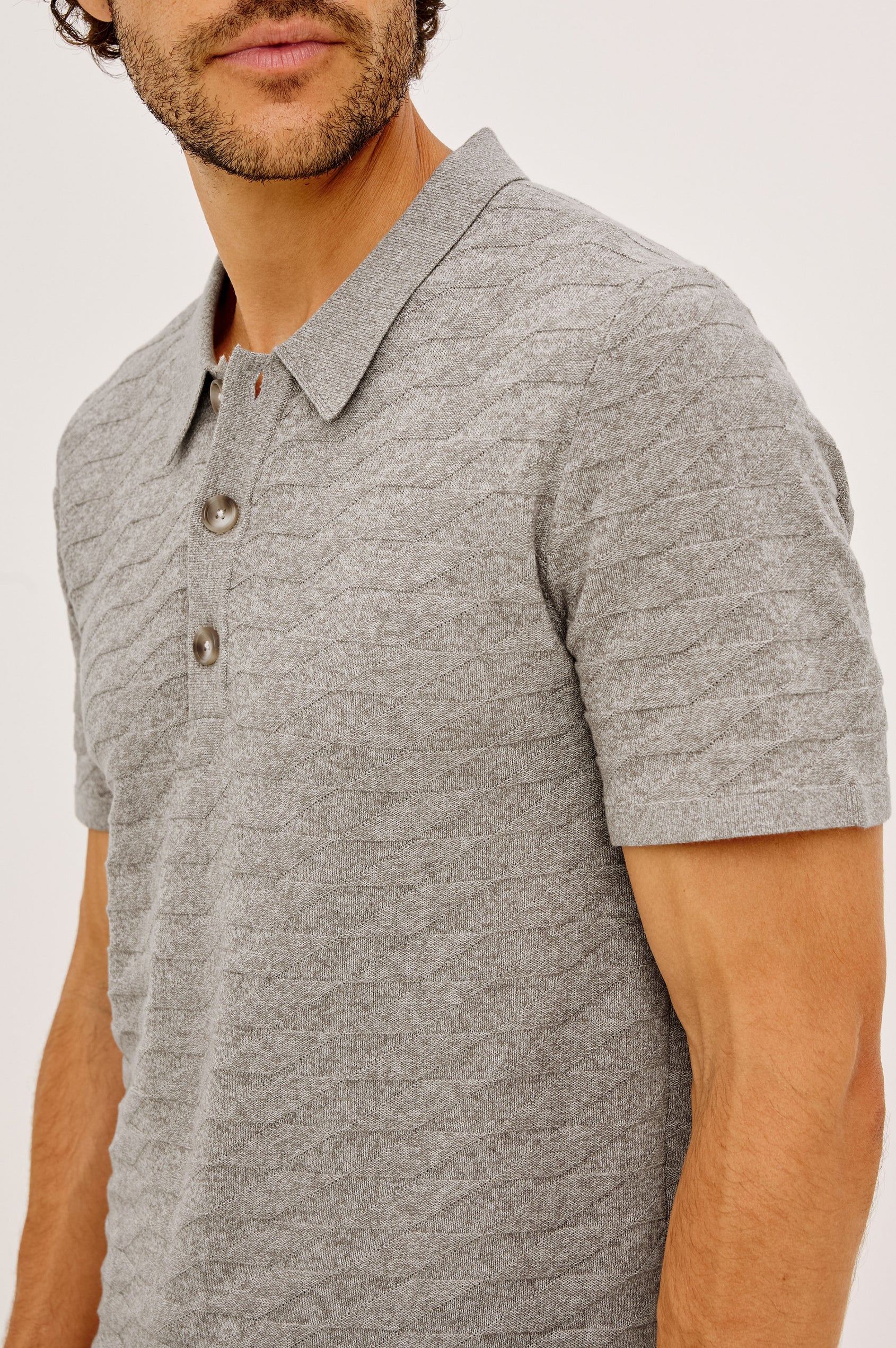 Linden Polo Shirt in Cotton Knit With Subtle Diamond Texture, Classic Fit, Quarter Button Placket, Short Sleeves, and Ribbed Trim in Heather Grey Prism Colorway - Upper Body Front View Featured on Model
