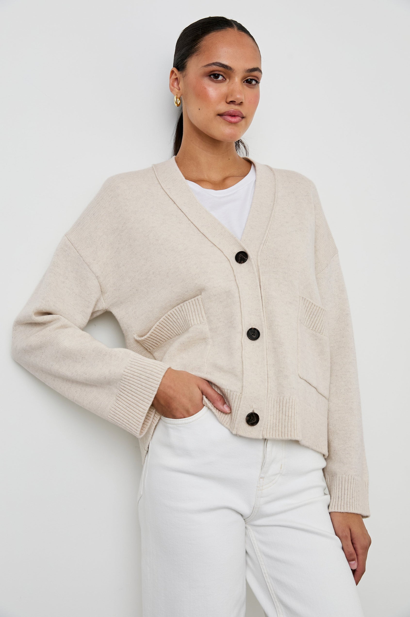 Lindi Long-Sleeve V Neck Cardigan with Three Button Closure, Two Front Patch Pockets and Ribbed Trim in Oatmeal Colorway - Front View Featured on Model