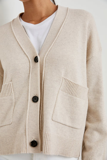 Lindi Long-Sleeve V Neck Cardigan with Three Button Closure, Two Front Patch Pockets and Ribbed Trim in Oatmeal Colorway - Front View Featured on Model