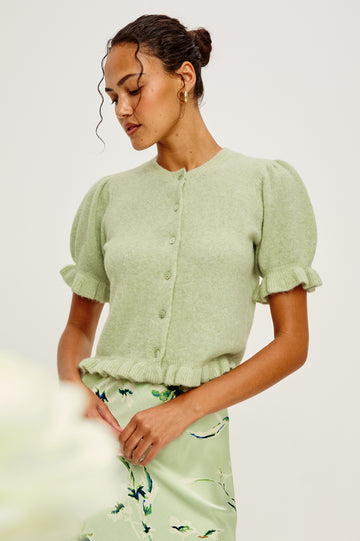 Lora Wool Cardigan With Crewneck Short Puff Sleeves and Hem With Ruffle Trim and Front Buttons in Julep Colorway - Upper Body Front View Featured on Model