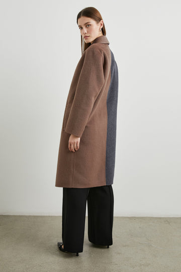 Lore Knee-Length Coat with Two Button Closure, Notched Lapels and Two Front Pockets in Charcoal Mink Mix Colorway, Left Half of Jacket is Mink and the Right Half is Charcoal  - Side Full Body View Featured on Model