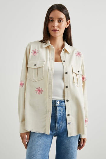 Loren Long-Sleeve Shirt Jacket with Button Closure, Two Chest Button Flap Pockets and a Raw Hem in Ecru Colorway, with Pink Flowers - Front View Featured on Model