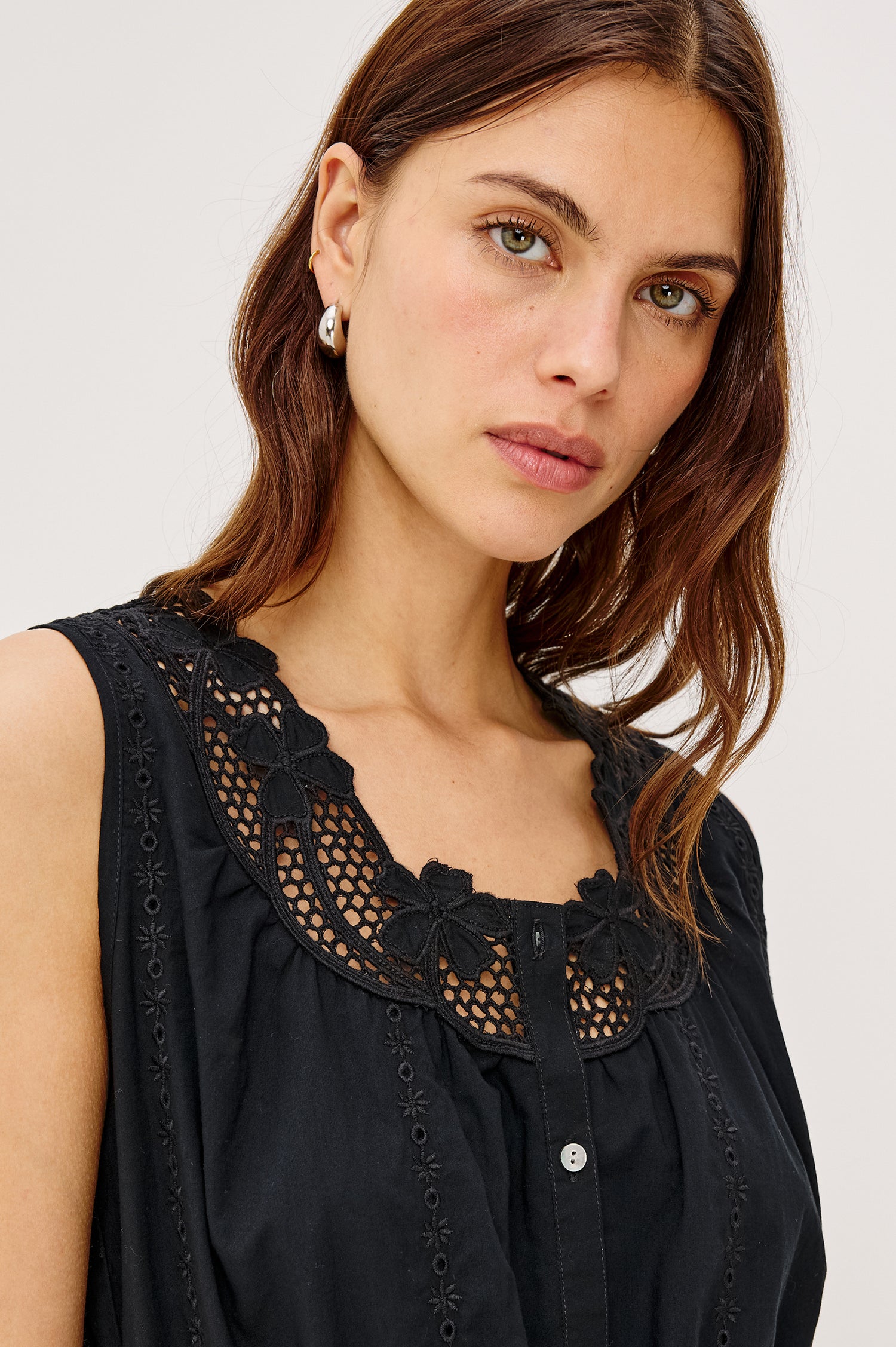 Lorina Midi Dress in Cotton Voile With Lattice and Floral Embroidery, Sleeveless Cut, and Adjustable Waist Ties in Black Colorway - Full Body Front View Featured on Model