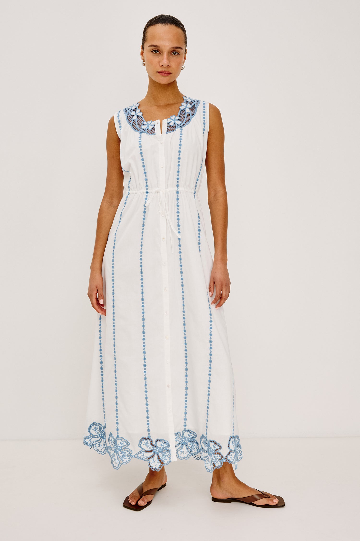 Lorina Midi Dress in Cotton Voile With Contrast Lattice and Floral Embroidery, Sleeveless Cut, and Adjustable Waist Ties in White Colorway - Full Body Front View Featured on Model