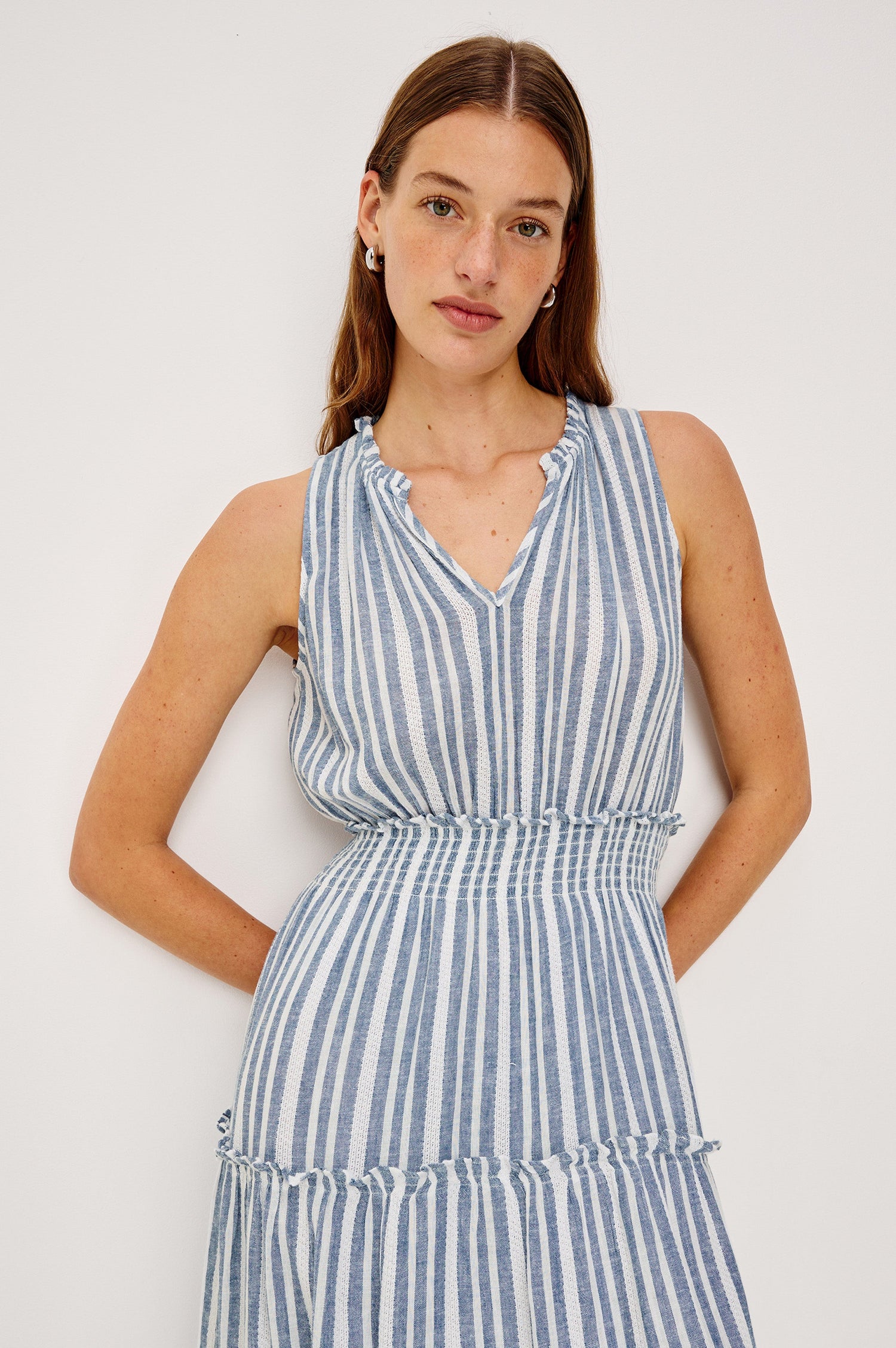 Loulou V-Neck Midi Dress with Smocked Elastic Waistband and a Multi Tiered Skirt in Blue/White Jalisco Stripe Colorway. Front Detail View Shown on Model.