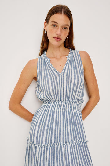 Loulou V-Neck Midi Dress with Smocked Elastic Waistband and a Multi Tiered Skirt in Blue/White Jalisco Stripe Colorway. Front Detail View Shown on Model.
