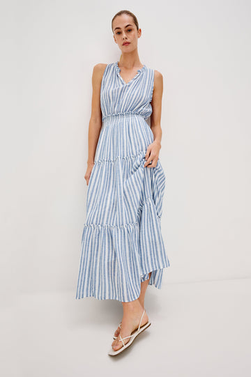 Loulou V-Neck Midi Dress with Smocked Elastic Waistband and a Multi Tiered Skirt in Blue/White Jalisco Stripe Colorway. Full Body Front View Shown on Model.