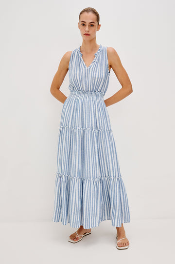 Loulou V-Neck Midi Dress with Smocked Elastic Waistband and a Multi Tiered Skirt in Blue/White Jalisco Stripe Colorway. Full Body Front View Shown on Model.