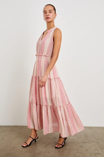 Front view of female model wearing our sleeveless, Loulou Maxi Dress in color Salerno Stripe, a pink and white boho stripe. Dress features smocked waist, v-neck, and tiered maxi skirt. 