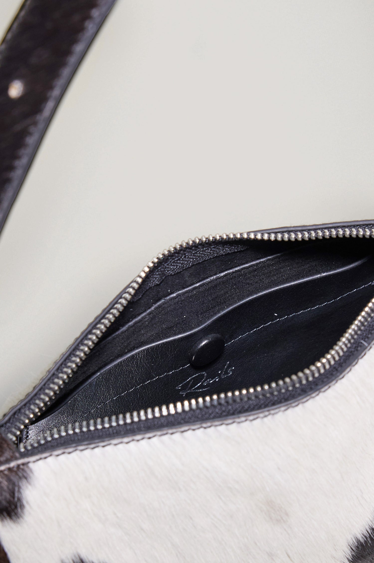 Lucca Shoulder Bag in Calfhair With Adjustable Strap and Polished Silver Buckle, Microsuede Lining, and Snap Button Interior Slip Pocket in Cowgirl Haircalf Colorway - Top Close Up View Featured