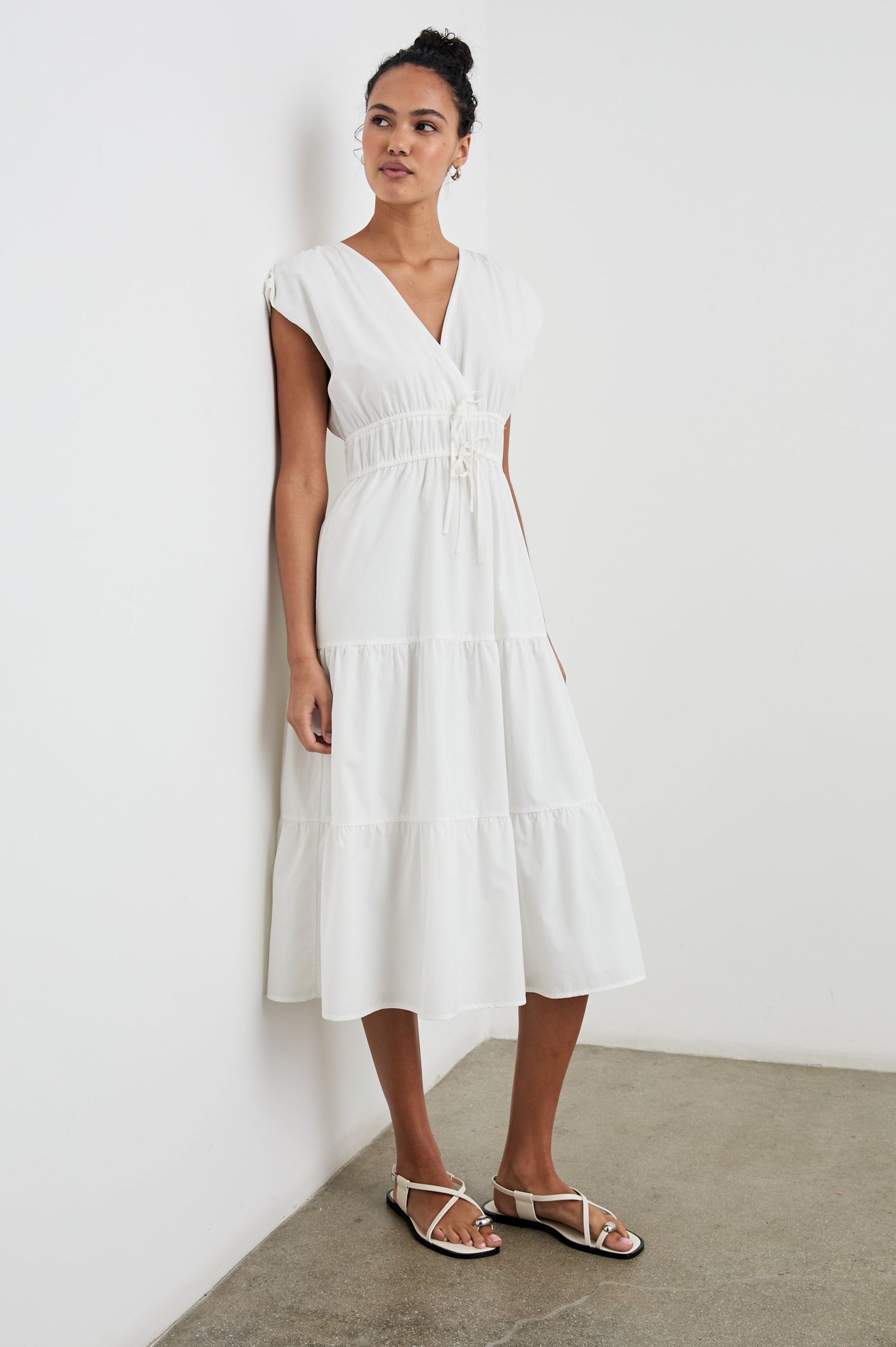 Lucia Midi Dress with Cap Sleeves, a Crossover V neckline, an Elastic Waist with Ties, and a Tiered Skirt in White Colorway - Front Full Body View Featured on Model