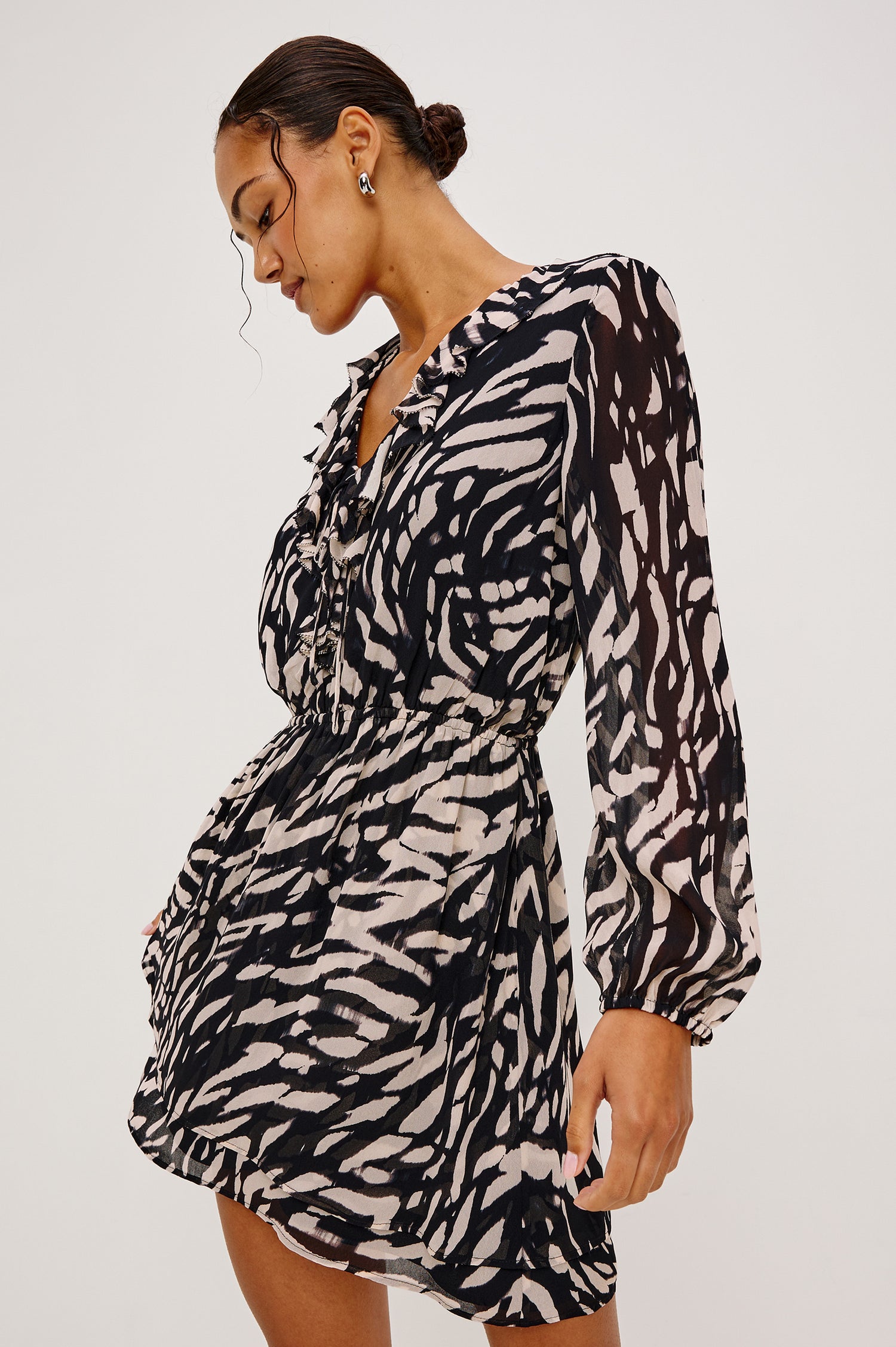 Lucresia Mini Dress in Chiffon With a Ruffle V-Neckline With Self-Ties, Long Lantern Sleeves, Elasticated Waist, and Lined Body in Ivory Tiger Stripe Colorway - Upper Body Front View Featured on Model