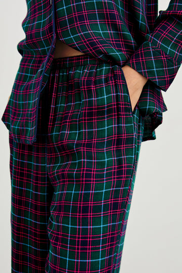 Luna Pajama Set with a Long Sleeve, Button Up, V Neck Top with a Chest Patch Pocket and Pants with Two Front Pockets in Evergreen Fuchsia Ice Colorway, a plaid - Front View Featured on Model  