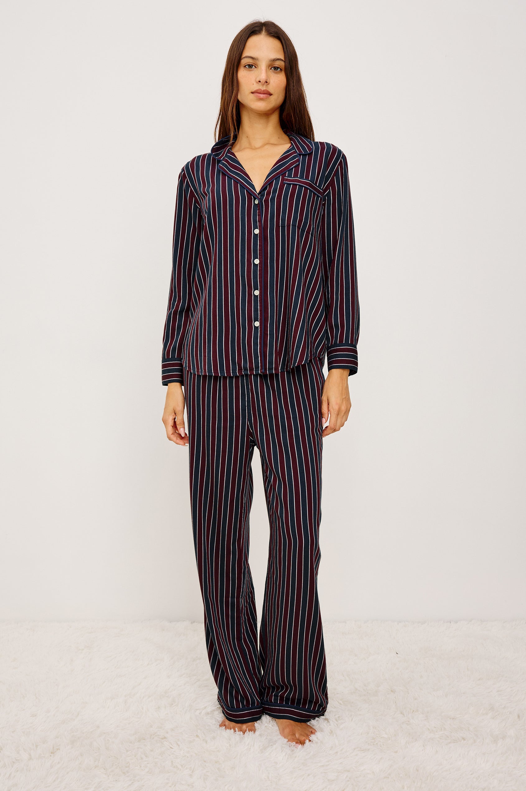 Luna Pajama Set in Signature Rayon With Button-Up Collared Shirt With Front Buttons, Long Sleeves, Chest Patch Pocket and Matching Pant With Side Pockets and Drawstring Waist Ties in Navy Oxblood Stripe Colorway - Full Body Front View Featured on Model