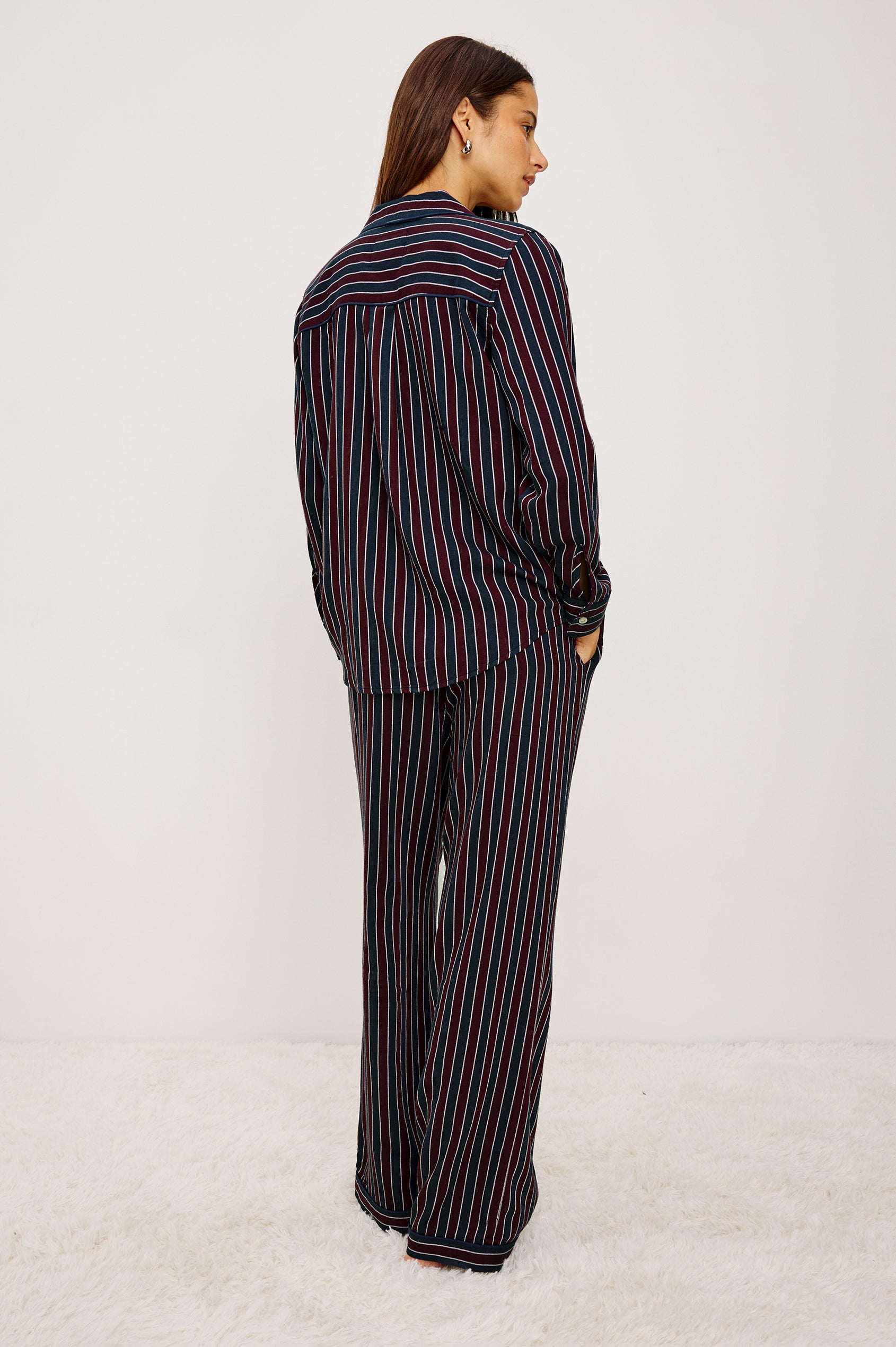 Luna Pajama Set in Signature Rayon With Button-Up Collared Shirt With Front Buttons, Long Sleeves, Chest Patch Pocket and Matching Pant With Side Pockets and Drawstring Waist Ties in Navy Oxblood Stripe Colorway - Full Body Back View Featured on Model