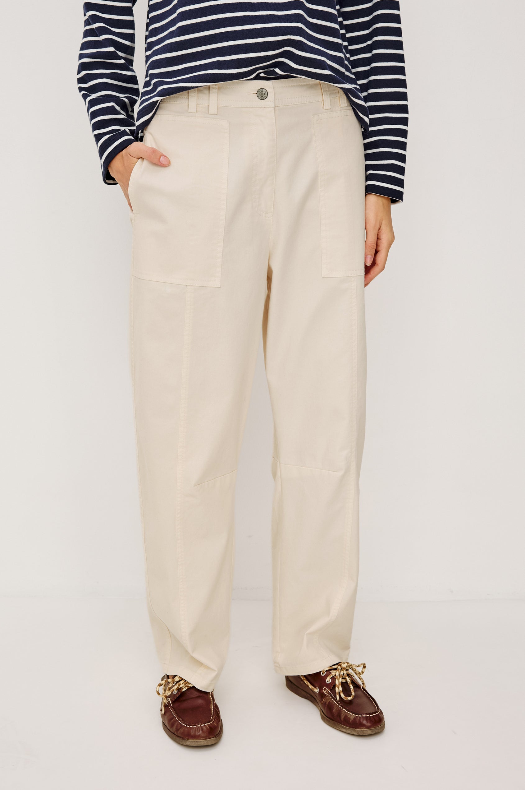 Lunar Pant in Stretch Corduroy With Relaxed Straight Legs, Zip-Fly Closure, Belt Loops, Seam Detailing, Carpenter-Style Side Pockets, and Back Pockets in Bone Colorway - Lower Body Front View Featured on Model