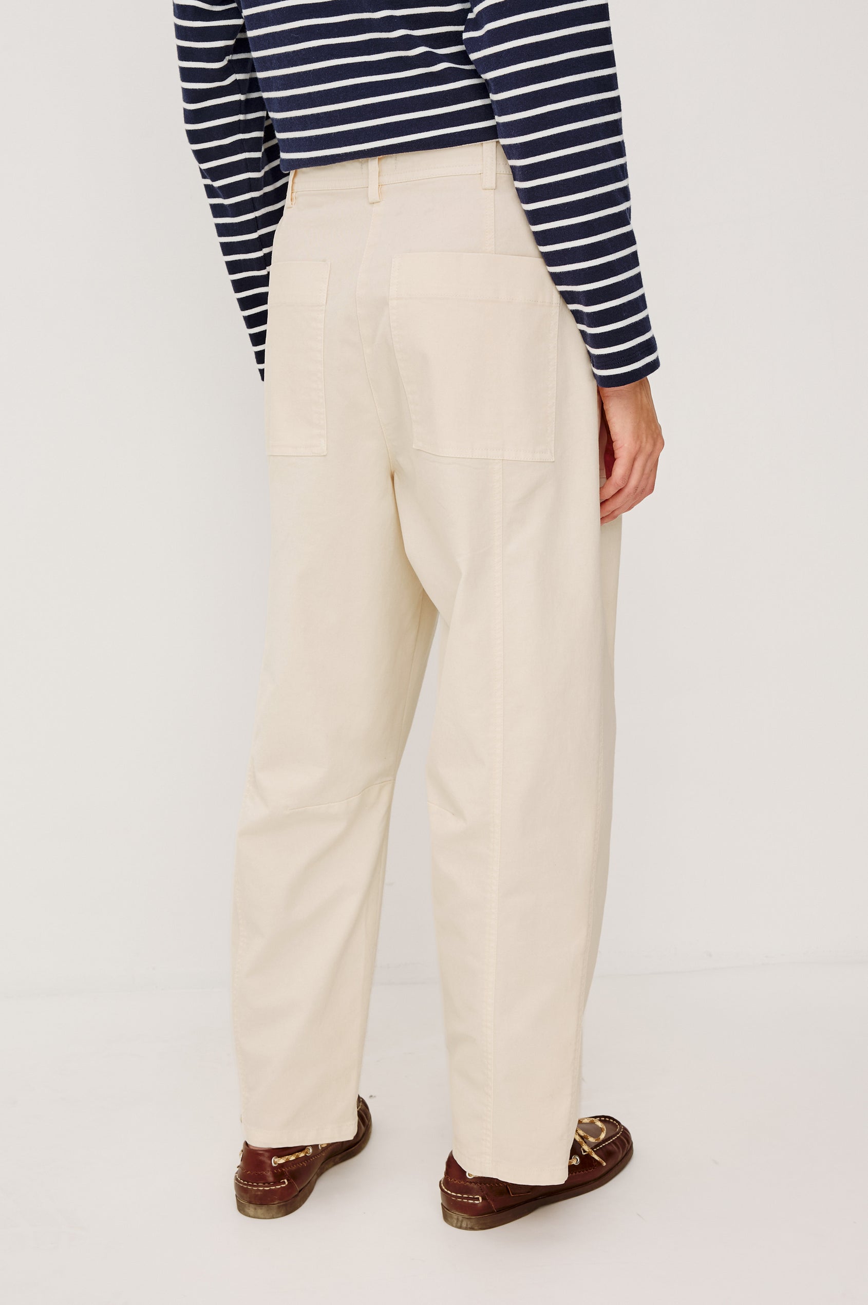 Lunar Pant in Stretch Corduroy With Relaxed Straight Legs, Zip-Fly Closure, Belt Loops, Seam Detailing, Carpenter-Style Side Pockets, and Back Pockets in Bone Colorway - Lower Body Back View Featured on Model