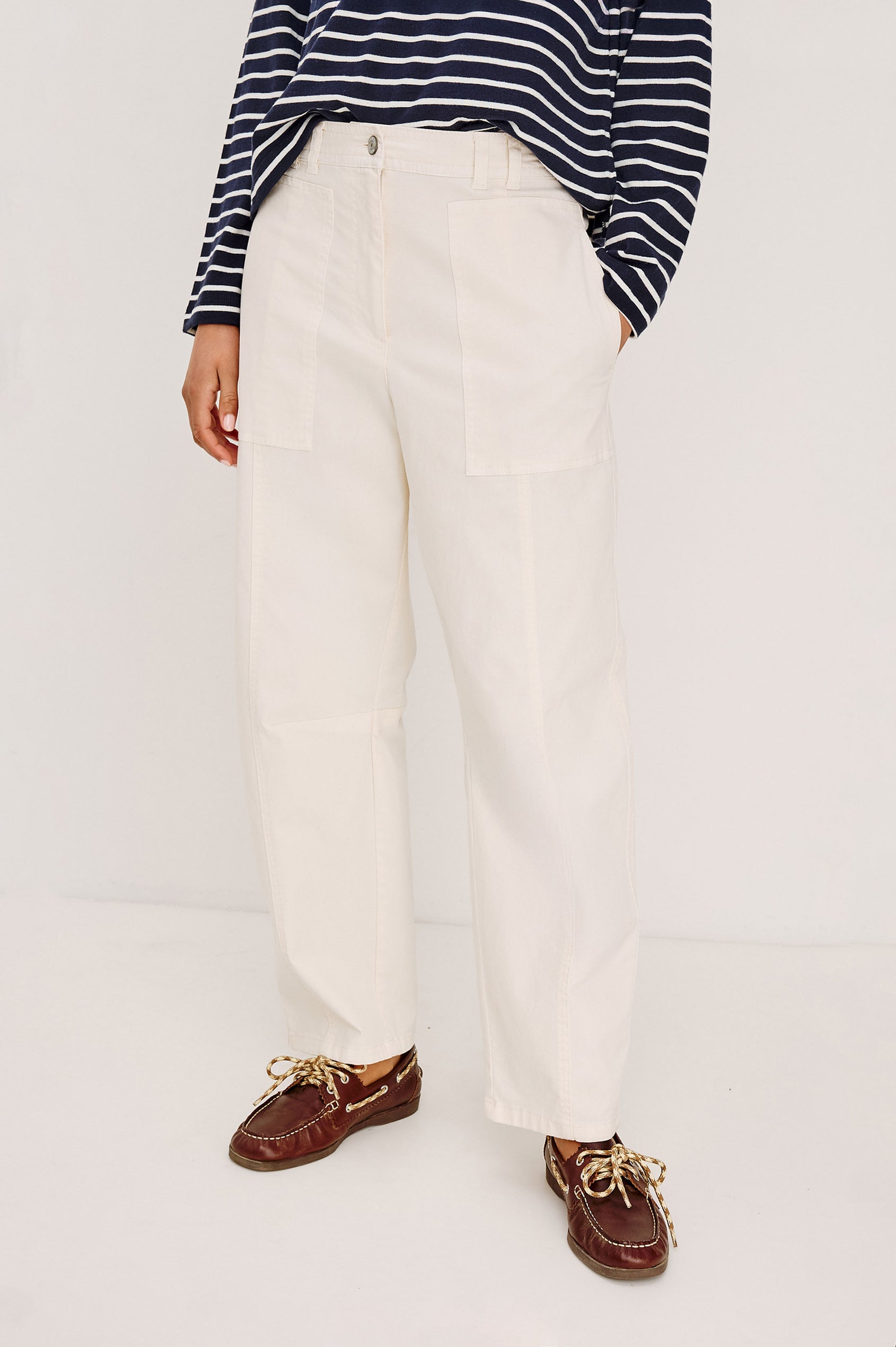 Lunar Pant in Stretch Corduroy With Relaxed Straight Legs, Zip-Fly Closure, Belt Loops, Seam Detailing, Carpenter-Style Side Pockets, and Back Pockets in Bone Colorway - Lower Body Front View Featured on Model