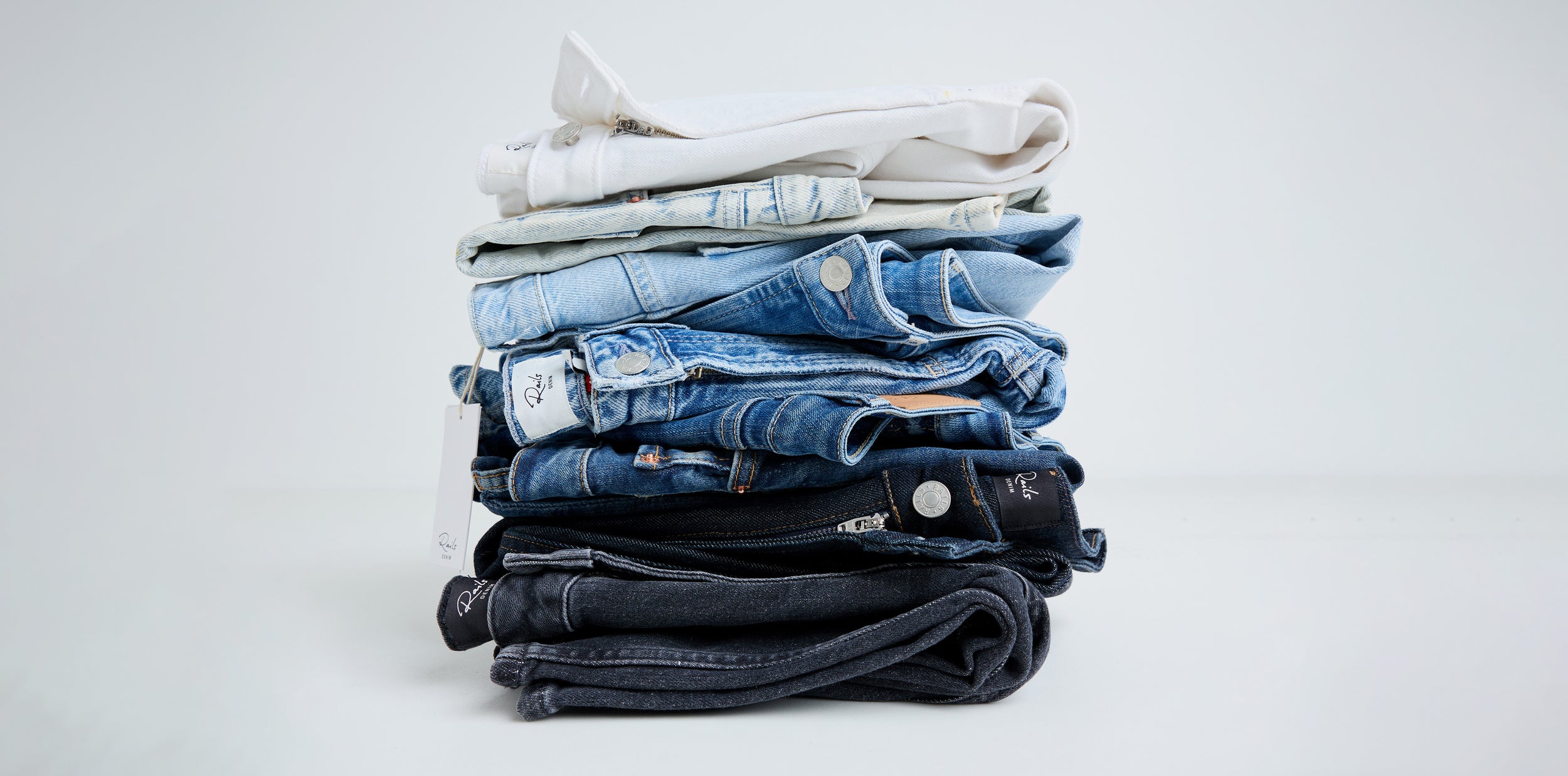 Stacked pair of jeans in variety of colors