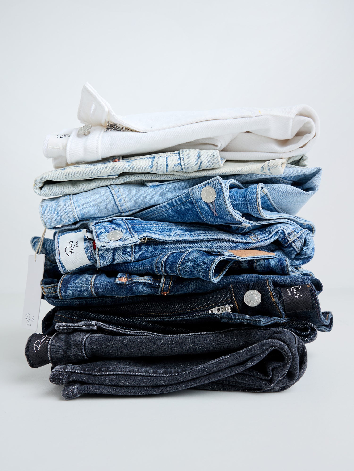 Stacked pair of jeans in variety of colors