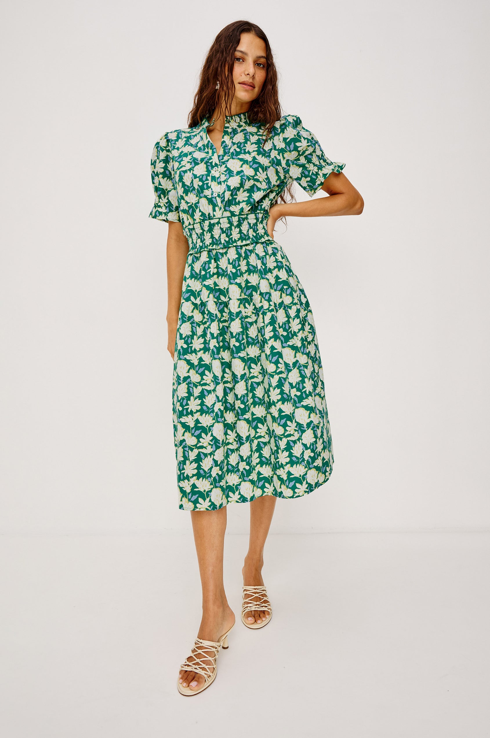 Makayla Midi Dress in Cotton Poplin With High Ruffled Neckline, Front Half Placket Buttons, Smocked Waist, and Short Puff Sleeves With Elastic in Green Mayflower Colorway - Full Body Front View Featured on Model