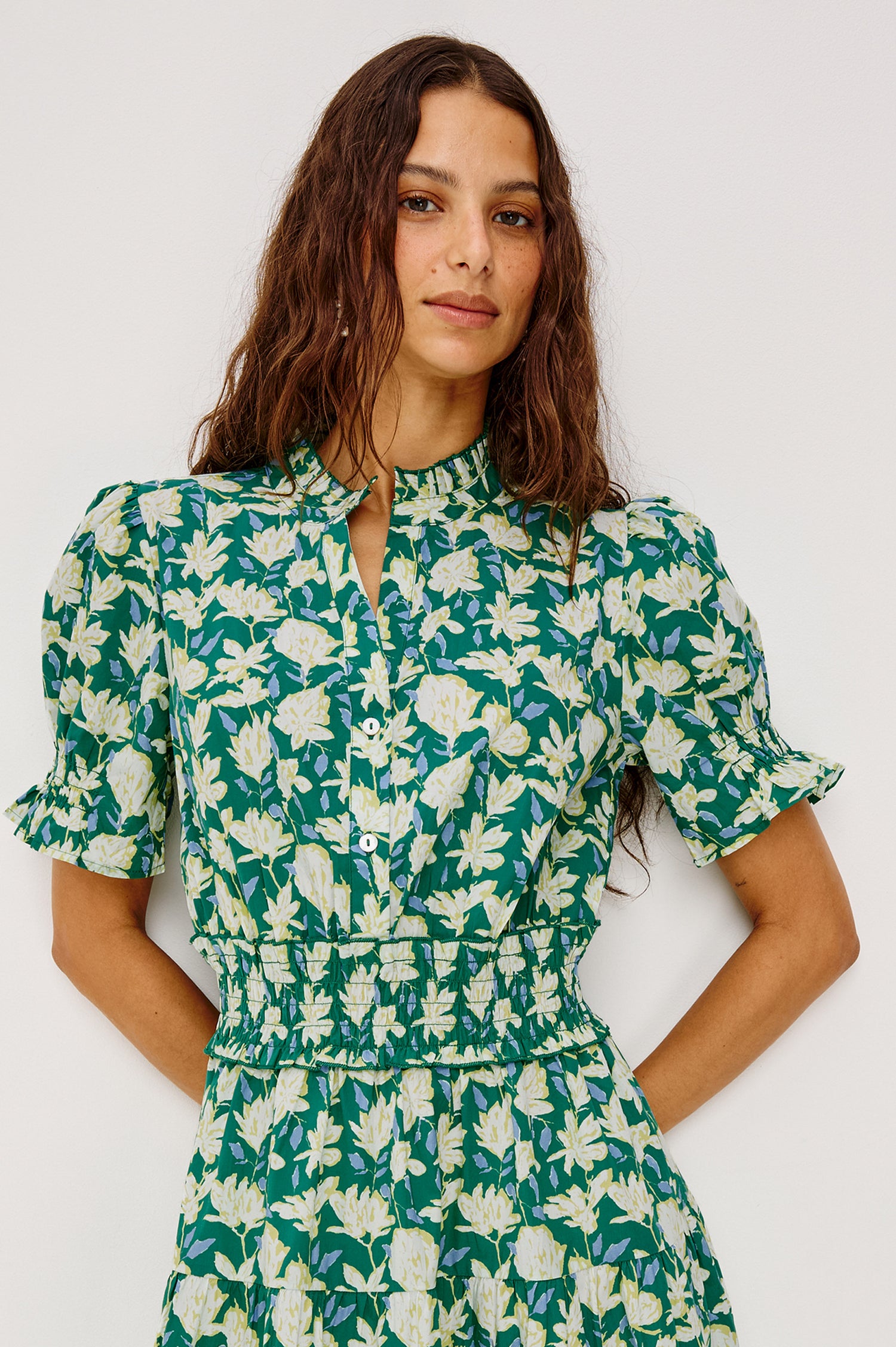 Makayla Midi Dress in Cotton Poplin With High Ruffled Neckline, Front Half Placket Buttons, Smocked Waist, and Short Puff Sleeves With Elastic in Green Mayflower Colorway - Upper Body Front View Featured on Model
