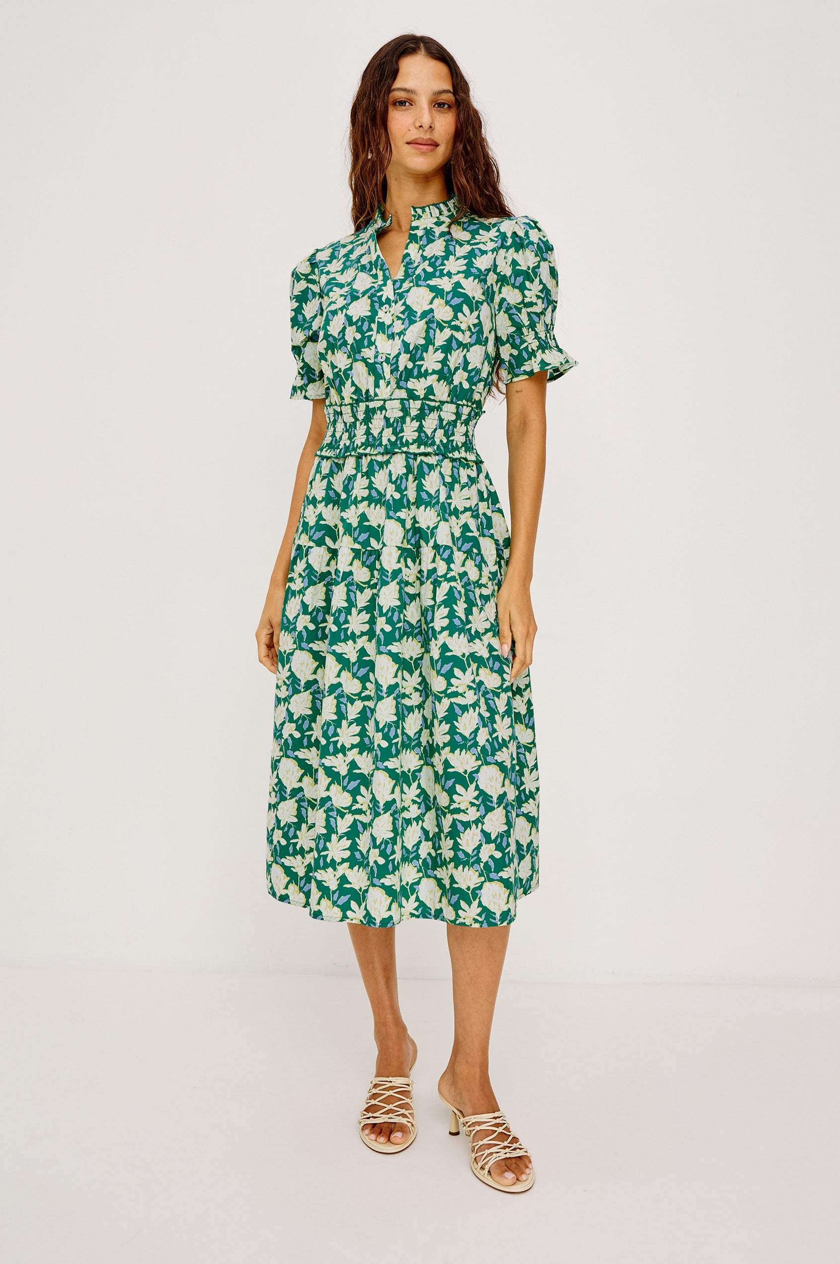 Makayla Midi Dress in Cotton Poplin With High Ruffled Neckline, Front Half Placket Buttons, Smocked Waist, and Short Puff Sleeves With Elastic in Green Mayflower Colorway - Full Body Front View Featured on Model