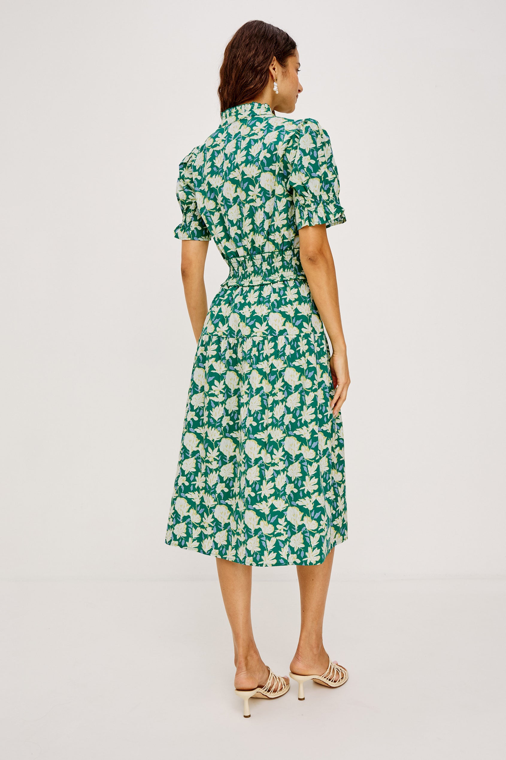 Makayla Midi Dress in Cotton Poplin With High Ruffled Neckline, Front Half Placket Buttons, Smocked Waist, and Short Puff Sleeves With Elastic in Green Mayflower Colorway - Full Body Back View Featured on Model