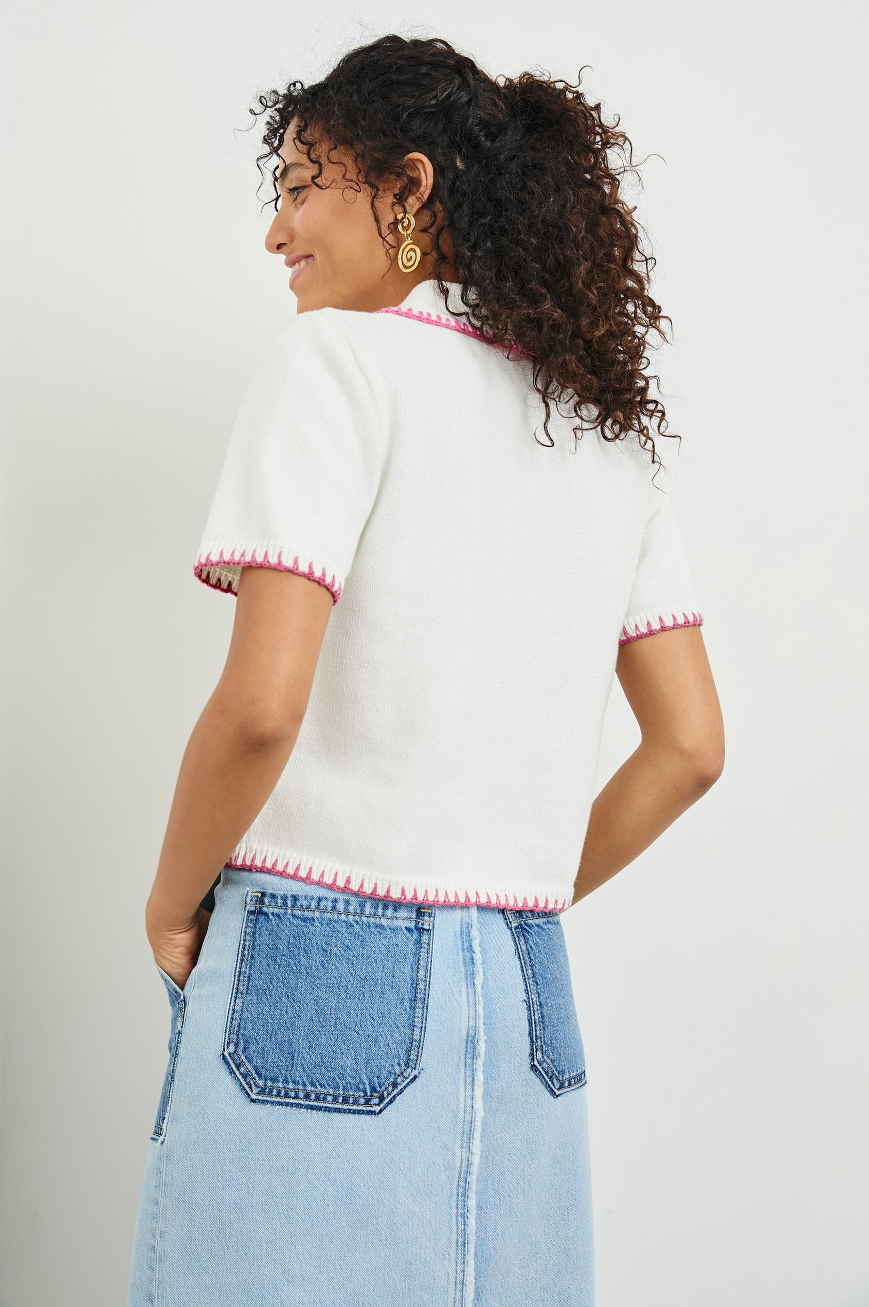 Maliah Short Sleeve Top with a Collar, Buttons Down the Front, and contrasting Blanket Stitches along the trim in Ivory Hibiscus Colorway with Hibiscus trim - Back View Featured on Model