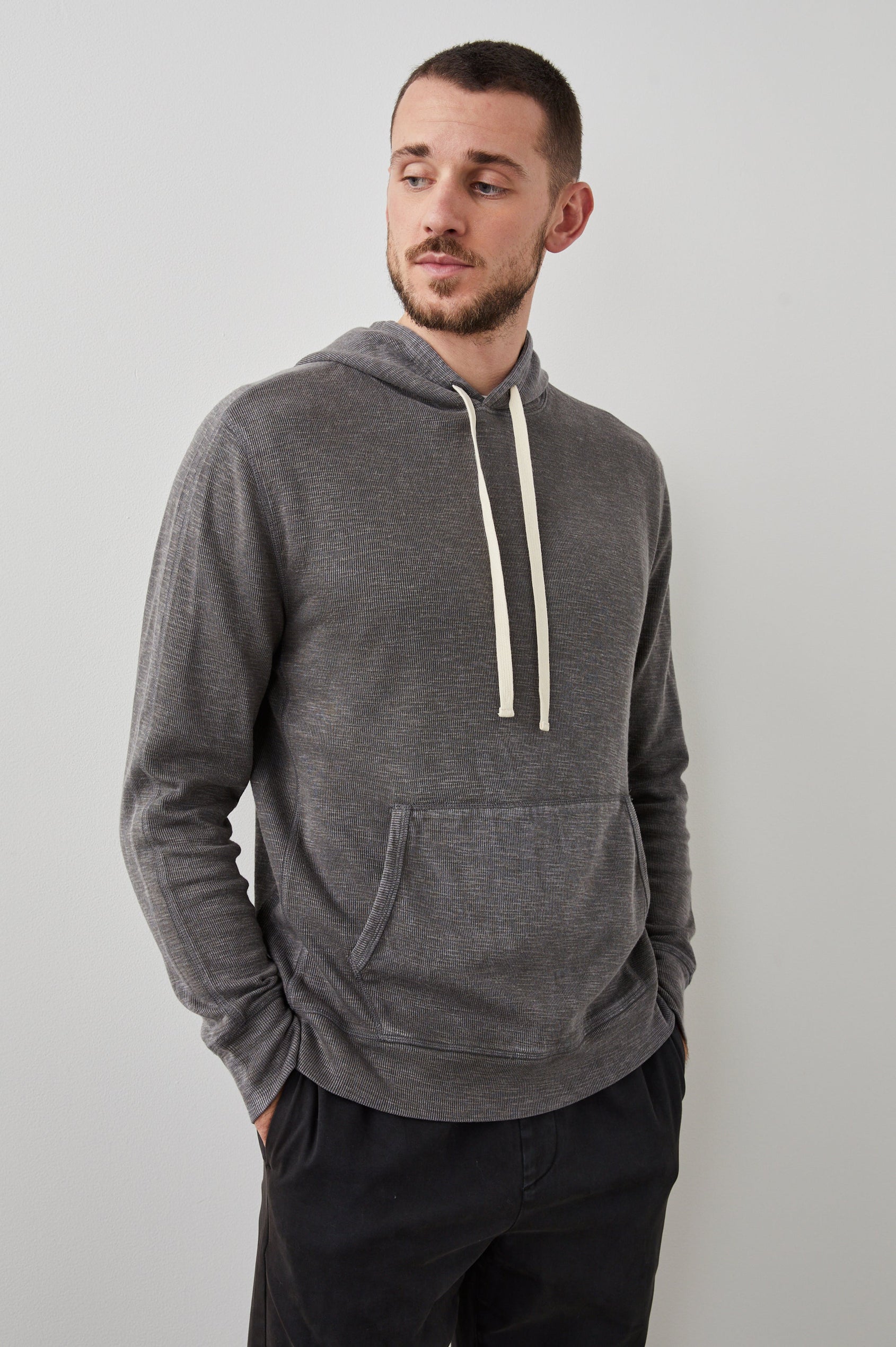 Mammoth Long-Sleeve Hoodie with a Kangaroo Pocket and Drawstring Hood in Washed Black Colorway - Front View Featured on Model