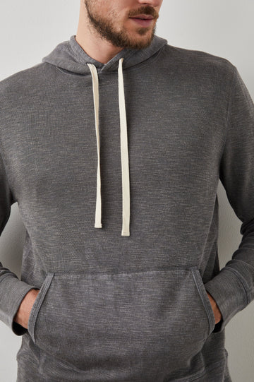 Mammoth Long-Sleeve Hoodie with a Kangaroo Pocket and Drawstring Hood in Washed Black Colorway - Front View Featured on Model