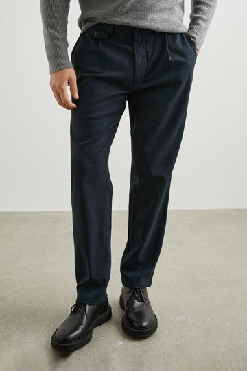 Marcellus Pants with Belt Loops, Two Seam Front Pockets, a Front Buttoned Flap Pocket, a Back Buttoned Welt Pocket and a Back Welt Pocket in Dark Navy Colorway - Front View Featured on Model 