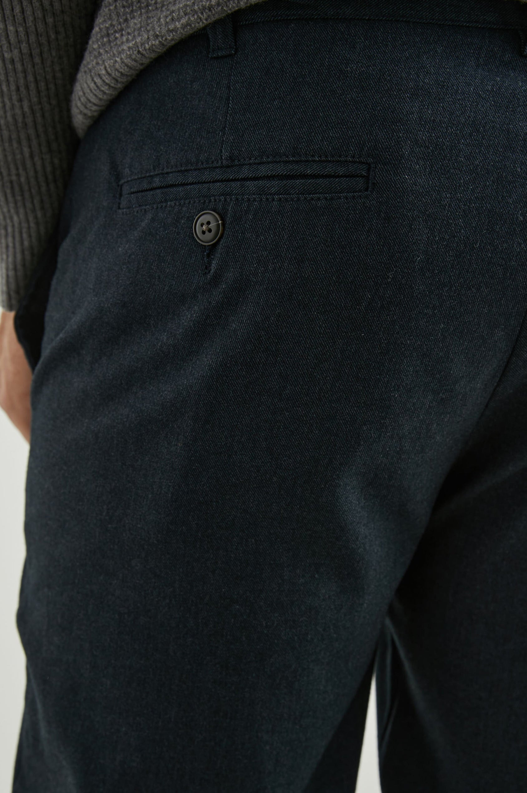 Marcellus Pants with Belt Loops, Two Seam Front Pockets, a Front Buttoned Flap Pocket, a Back Buttoned Welt Pocket and a Back Welt Pocket in Dark Navy Colorway - Back View Featured on Model 