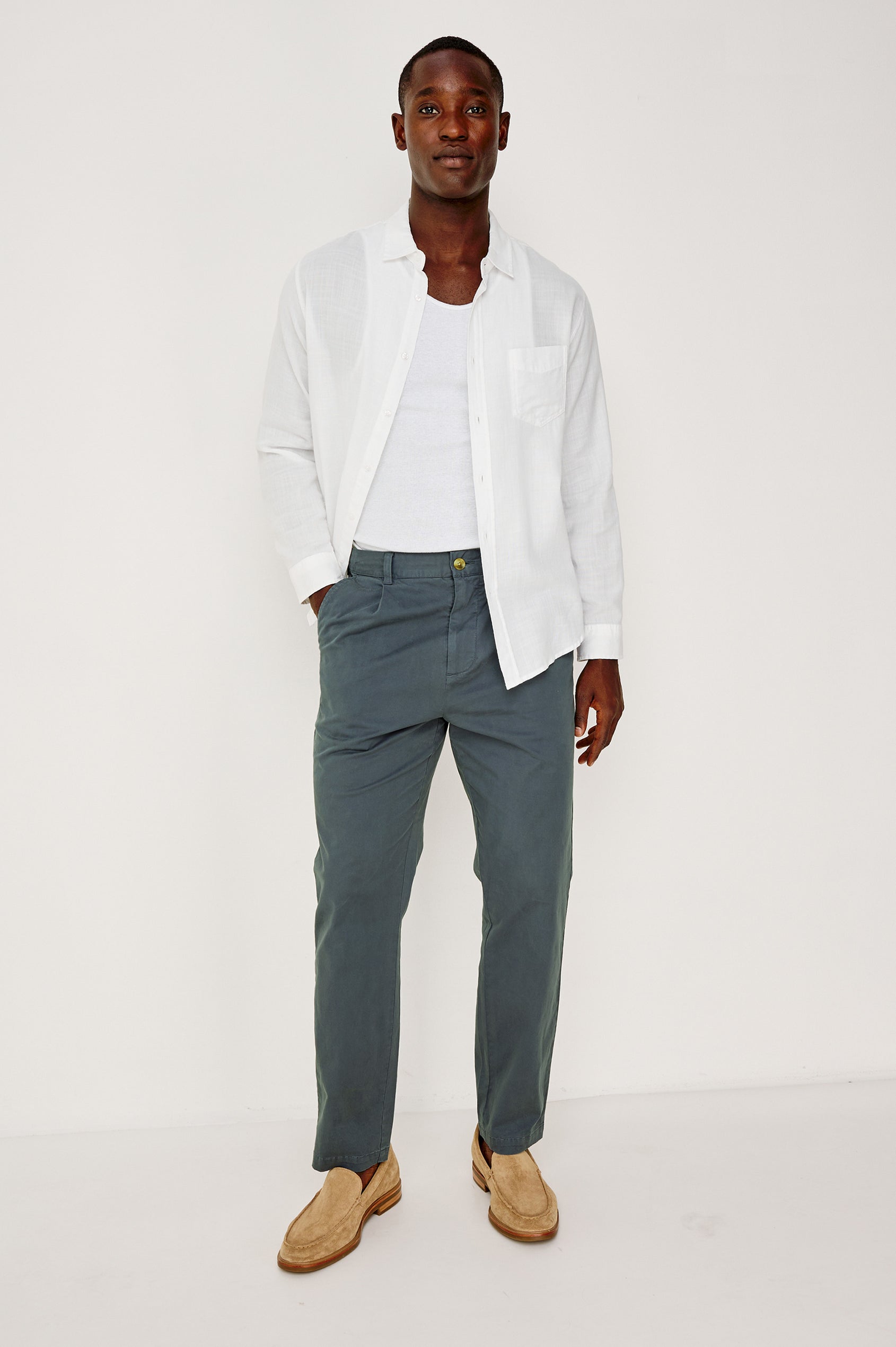 Marcellus Pants with Belt Loops, Two Seam Front Pockets, a Front Buttoned Flap Pocket, a Back Buttoned Welt Pocket and a Back Welt Pocket in Faded Blue Colorway - Front Full Body View Featured on Model