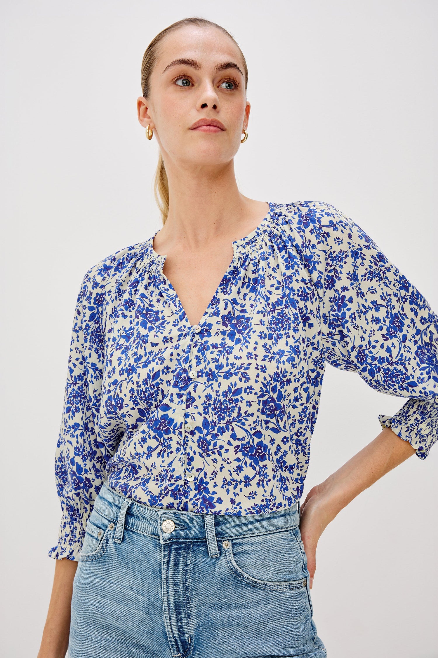 Mariah Button Down Shirt With 3/4" Length Sleeves with Elastic Smoking at Sleeve Hem, V-Neck and Half Button Front in Blue Marguerite Colorway - Front View Featured on Model.